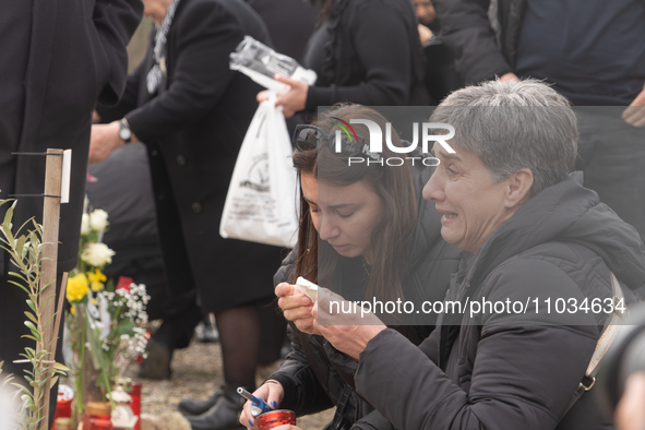 The mother of a young girl is crying in front of the sign that reads her deceased daughter's name, in Tempi Thessaly, Greece, on on February...