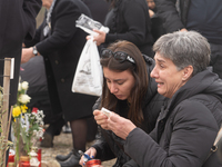 The mother of a young girl is crying in front of the sign that reads her deceased daughter's name, in Tempi Thessaly, Greece, on on February...