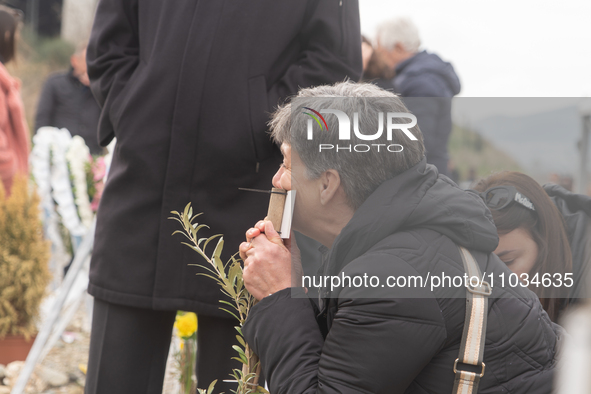 The mother of a young girl is crying in front of the sign that reads her deceased daughter's name, in Tempi Thessaly, Greece, on on February...