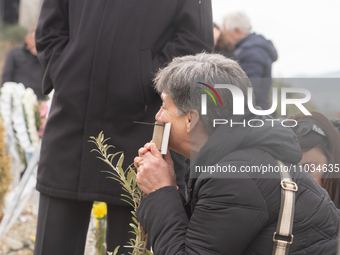 The mother of a young girl is crying in front of the sign that reads her deceased daughter's name, in Tempi Thessaly, Greece, on on February...