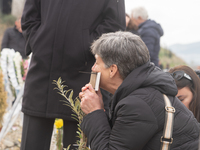 The mother of a young girl is crying in front of the sign that reads her deceased daughter's name, in Tempi Thessaly, Greece, on on February...