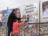 The husband of a young woman who was killed in a crash is hanging photos of her on the rail fence, in Tempi Thessaly, Greece, on on February...