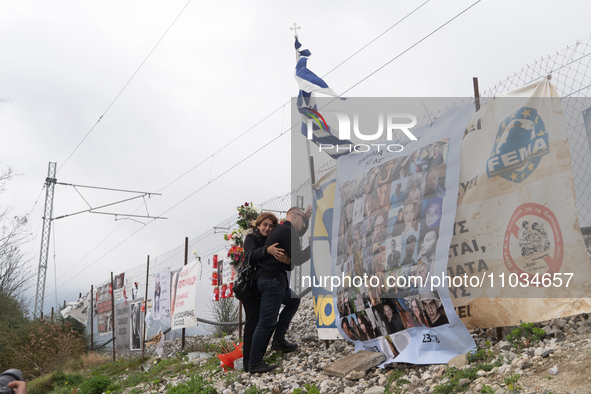 A relative of a girl who died while being a passenger on the train is hugging the wire fence of the railway track and mourning the loss of h...