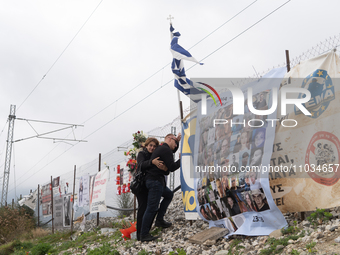 A relative of a girl who died while being a passenger on the train is hugging the wire fence of the railway track and mourning the loss of h...