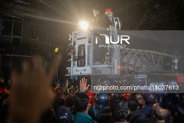 Firefighters are rescuing people from the roof after a fire broke out in a multi-storey building in Dhaka, Bangladesh, on February 29, 2024....