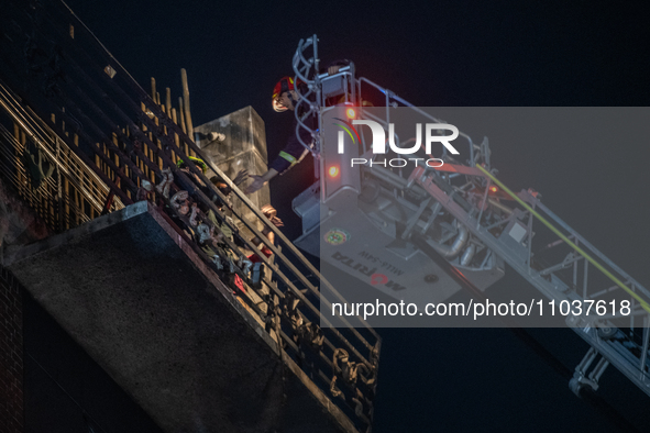 Firefighters are rescuing people from the roof after a fire broke out in a multi-storey building in Dhaka, Bangladesh, on February 29, 2024....