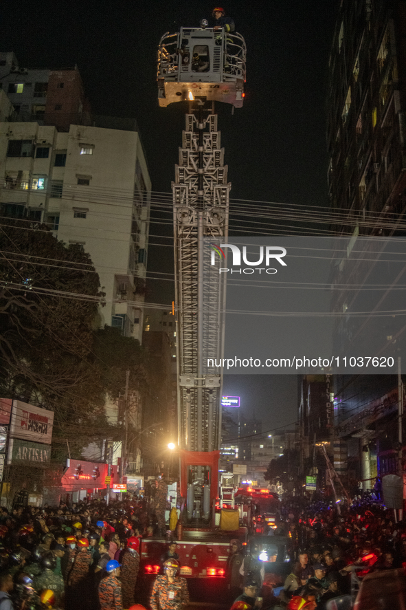 Firefighters are rescuing people from the roof after a fire broke out in a multi-storey building in Dhaka, Bangladesh, on February 29, 2024....