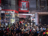 Curious onlookers are gathering at the site of a fire in a multi-storey building in Dhaka, Bangladesh, on February 29, 2024. At least 43 peo...