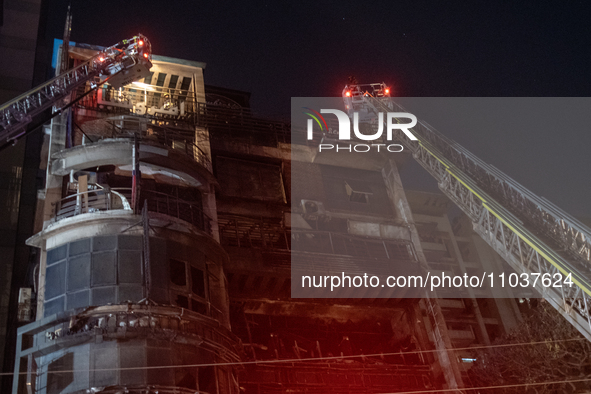 Firefighters are rescuing people from the roof after a fire broke out in a multi-storey building in Dhaka, Bangladesh, on February 29, 2024....