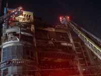 Firefighters are rescuing people from the roof after a fire broke out in a multi-storey building in Dhaka, Bangladesh, on February 29, 2024....