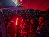 A BGB personnel is reacting to the camera while on duty at the site of a fire that broke out in a commercial building in Dhaka, Bangladesh,...