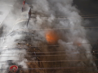 Firefighters are working to extinguish a fire in a commercial building that has killed at least 43 people in Dhaka, Bangladesh, on February...