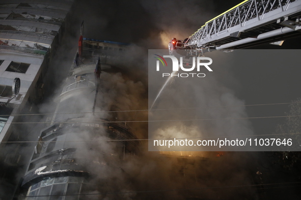 Firefighters are working to extinguish a fire in a commercial building that has killed at least 43 people in Dhaka, Bangladesh, on February...