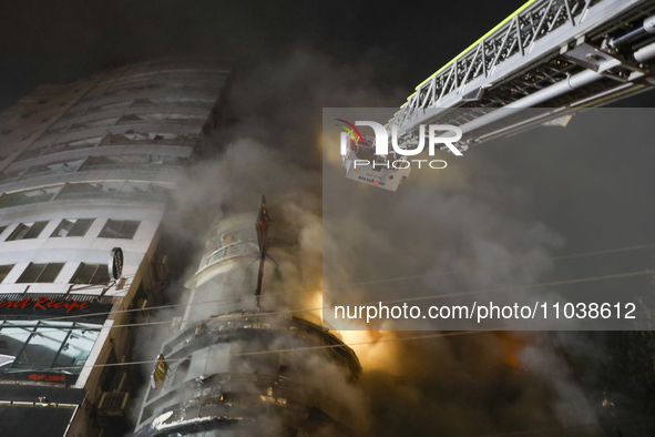 Firefighters are rescuing people from the roof after a fire broke out in a multi-story building in Dhaka, Bangladesh, on February 29, 2024....