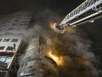 Firefighters are rescuing people from the roof after a fire broke out in a multi-story building in Dhaka, Bangladesh, on February 29, 2024....