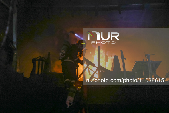 Firefighters are rescuing people from the roof after a fire broke out in a multi-story building in Dhaka, Bangladesh, on February 29, 2024....