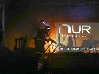 Firefighters are rescuing people from the roof after a fire broke out in a multi-story building in Dhaka, Bangladesh, on February 29, 2024....