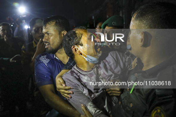 Survivors are reacting after being rescued by firefighters as a fire breaks out in a multi-story building in Dhaka, Bangladesh, on February...