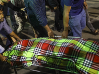 Relatives of the victims are receiving the bodies after a fire broke out in a multi-story building in Dhaka, Bangladesh, on February 29, 202...