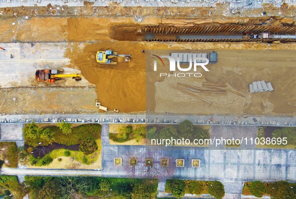 Workers are working on a flood control and drainage project at a construction site in Yuexi County, Anqing, China, on March 1, 2024. 