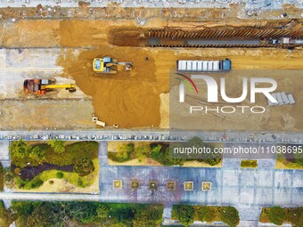 Workers are working on a flood control and drainage project at a construction site in Yuexi County, Anqing, China, on March 1, 2024. (