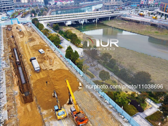 Workers are working on a flood control and drainage project at a construction site in Yuexi County, Anqing, China, on March 1, 2024. 