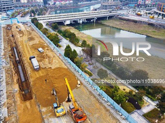 Workers are working on a flood control and drainage project at a construction site in Yuexi County, Anqing, China, on March 1, 2024. (