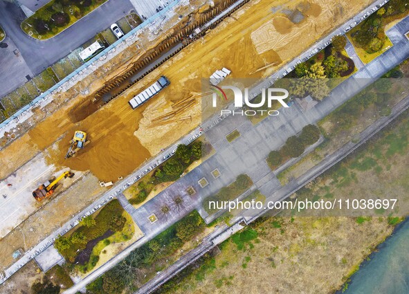 Workers are working on a flood control and drainage project at a construction site in Yuexi County, Anqing, China, on March 1, 2024. 