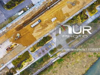 Workers are working on a flood control and drainage project at a construction site in Yuexi County, Anqing, China, on March 1, 2024. (