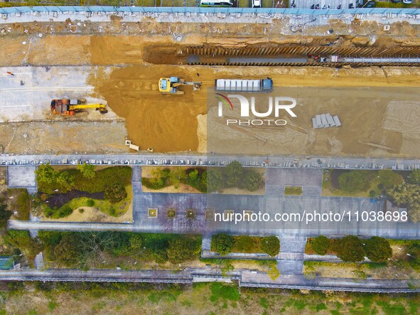 Workers are working on a flood control and drainage project at a construction site in Yuexi County, Anqing, China, on March 1, 2024. 