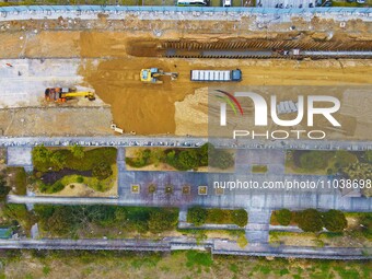 Workers are working on a flood control and drainage project at a construction site in Yuexi County, Anqing, China, on March 1, 2024. (