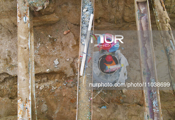 Workers are working on a flood control and drainage project at a construction site in Yuexi County, Anqing, China, on March 1, 2024. 