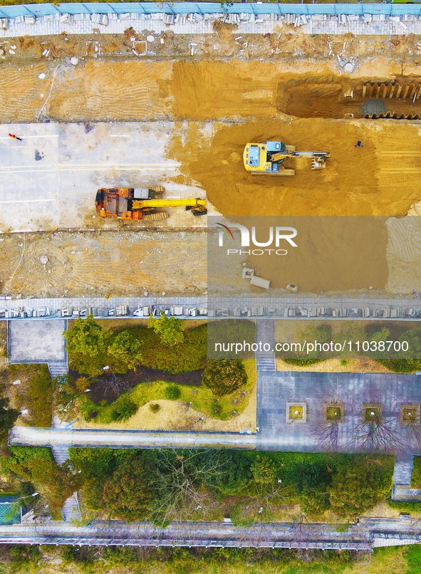 Workers are working on a flood control and drainage project at a construction site in Yuexi County, Anqing, China, on March 1, 2024. 