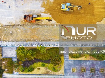 Workers are working on a flood control and drainage project at a construction site in Yuexi County, Anqing, China, on March 1, 2024. (