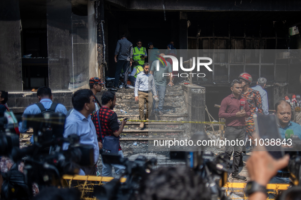 Firefighters and forensic experts are inspecting a commercial building in Dhaka, Bangladesh, on March 1, 2024, the day after a fire claimed...