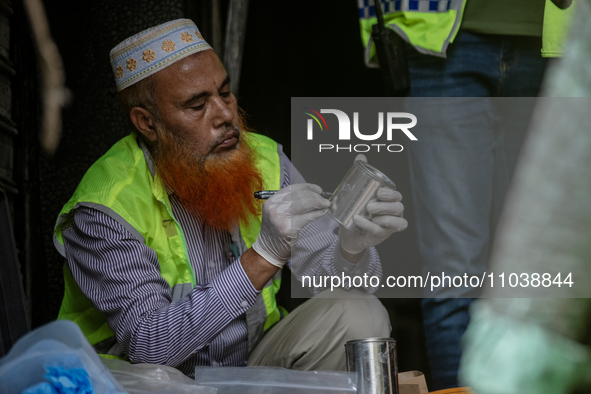 Firefighters and forensic experts are inspecting a commercial building in Dhaka, Bangladesh, on March 1, 2024, the day after a fire claimed...