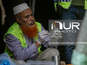 Firefighters and forensic experts are inspecting a commercial building in Dhaka, Bangladesh, on March 1, 2024, the day after a fire claimed...