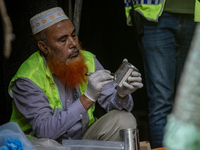 Firefighters and forensic experts are inspecting a commercial building in Dhaka, Bangladesh, on March 1, 2024, the day after a fire claimed...