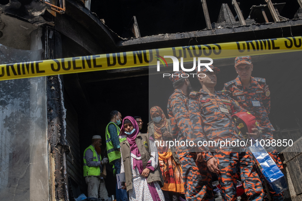 Firefighters and forensic experts are inspecting a commercial building in Dhaka, Bangladesh, on March 1, 2024, the day after a fire claimed...