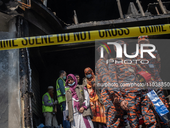 Firefighters and forensic experts are inspecting a commercial building in Dhaka, Bangladesh, on March 1, 2024, the day after a fire claimed...