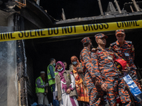 Firefighters and forensic experts are inspecting a commercial building in Dhaka, Bangladesh, on March 1, 2024, the day after a fire claimed...