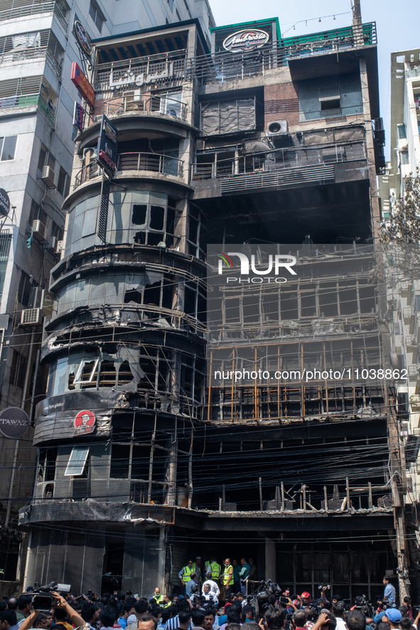 Firefighters and forensic experts are inspecting a commercial building in Dhaka, Bangladesh, on March 1, 2024, the day after a fire claimed...