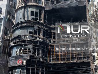 Firefighters and forensic experts are inspecting a commercial building in Dhaka, Bangladesh, on March 1, 2024, the day after a fire claimed...