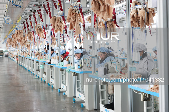 Workers at a toy export enterprise are producing plush toys for export in Lianyungang, China, on March 2, 2024. 