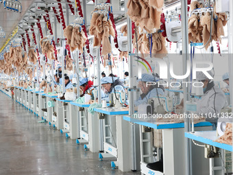 Workers at a toy export enterprise are producing plush toys for export in Lianyungang, China, on March 2, 2024. (