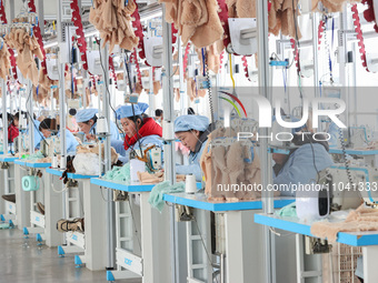 Workers at a toy export enterprise are producing plush toys for export in Lianyungang, China, on March 2, 2024. (