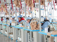 Workers at a toy export enterprise are producing plush toys for export in Lianyungang, China, on March 2, 2024. (