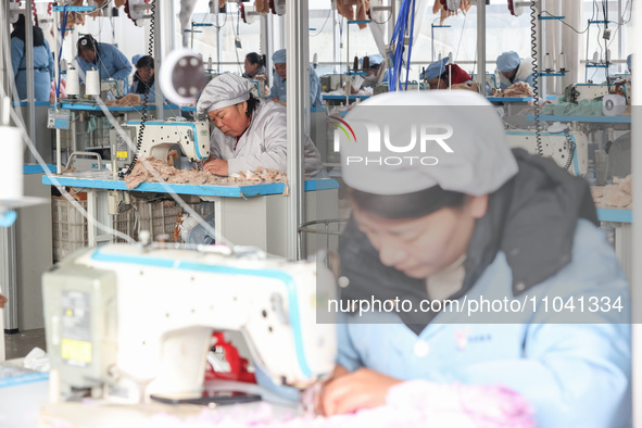 Workers at a toy export enterprise are producing plush toys for export in Lianyungang, China, on March 2, 2024. 