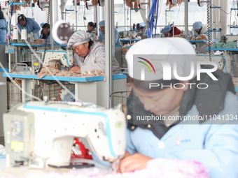 Workers at a toy export enterprise are producing plush toys for export in Lianyungang, China, on March 2, 2024. (