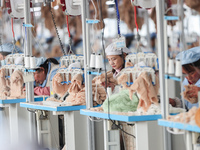 Workers at a toy export enterprise are producing plush toys for export in Lianyungang, China, on March 2, 2024. (